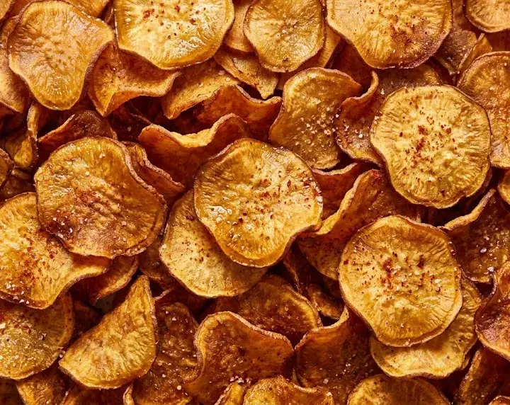 Crispy Air Fryer Sweet Potato Chips — Quick Snack Pile of crispy air fryer sweet potato chips with golden edges and light seasoning